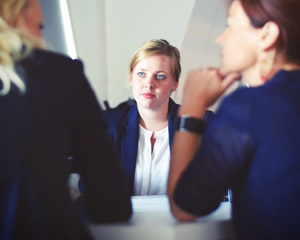 Managers in a meeting across a boardroom table