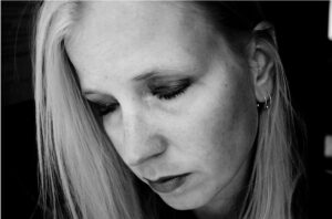 Image of depressed woman to illustrate question of whether employees should tell their employer about their medical condition